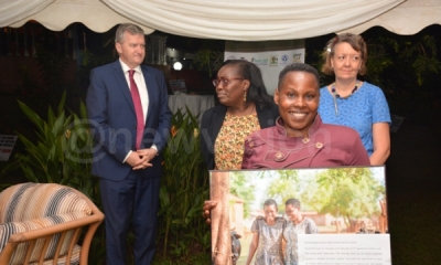 (Background left to right): William Carlos, the ambassador of Ireland to Uganda, Caroline Kego, a social development advisor at the embassy and Aine Doody, the head of co-operation, Irish embassy, pay tribute to Harriet Nabirye (foreground), a survivor of gender-based violence (PHOTO: New Vision)